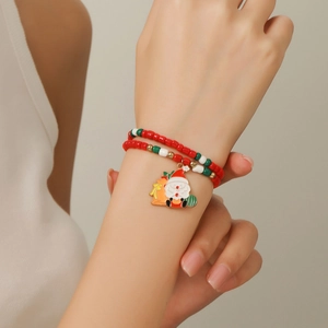 Christmas multilayer beaded bracelet with Santa Claus charm worn on a model's wrist