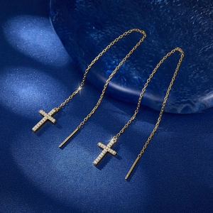 Detail shot of gold S925 silver cross threader earrings with micro-set cubic zirconia
