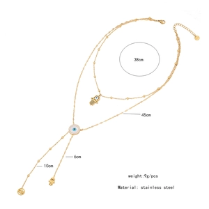 Detailed size chart of a gold double-layer stainless steel necklace with evil eye charm