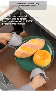 Shark-shaped silicone oven mitts holding a hot plate, heat resistant up to 230 degrees