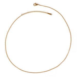 Close-up of golden stainless steel chain with lobster clasp and adjustable extension link