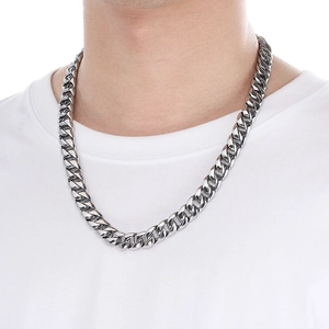 Close-up of a model wearing a polished 12mm silver Cuban link necklace in hip hop style