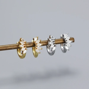 Detailed close-up of S925 silver stud earrings with marquise cubic zirconia in gold and silver