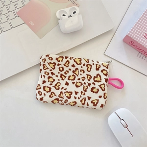 Detailed close-up of a leopard heart print coin purse with pink lanyard and metal zipper