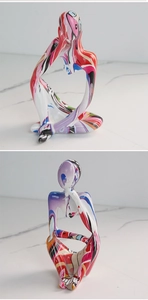 Close-up of abstract thinker sculpture with vibrant multi-color graffiti resin finish