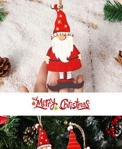 Detail of wooden Christmas gnome ornament hanging on a festive pine tree with pinecones