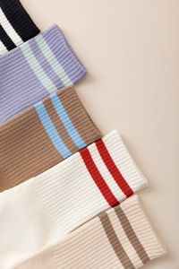 Close-up of five pairs of ribbed cotton yoga five-toe socks with striped cuff details