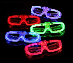 Close-up of five LED glasses in red blue and green glowing against a dark background