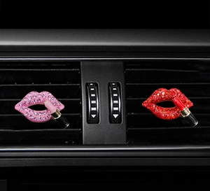 Detail of red and pink rhinestone lip and lipstick shaped car air vent clips