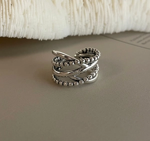 Close-up of a 925 sterling silver multilayer ring with beaded and smooth textures