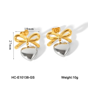 Detailed view of two-tone bow heart earrings with 19mm and 27mm dimensions