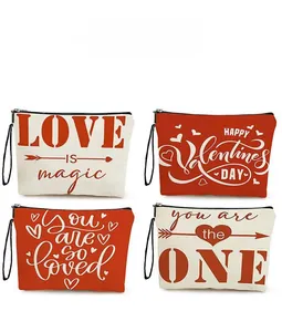Detail showing four Valentine's Day canvas makeup bags with red heart patterns and zippers