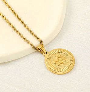 Macro shot of 18k gold plated Aquarius zodiac round pendant with elegant rope chain detail