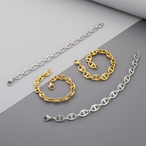 Detail of interlocking pig nose link bracelets in polished gold and silver finishes