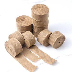 Macro shot of natural jute burlap ribbon rolls with rustic texture for DIY crafts