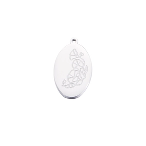 Close-up of engraved silver oval stainless steel birthday flower pendant on white base