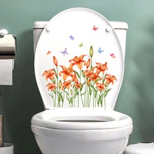 Detail of self-adhesive bathroom sticker with orange lilies and colorful butterflies