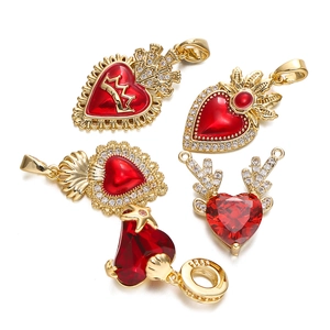 Detailed macro view of 18K gold plated heart and wing charms with S925 engraving