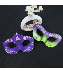 Detail of DIY masquerade masks with purple and green glitter patterns for parties