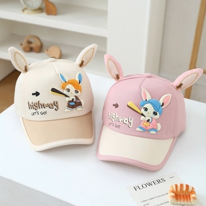 Detailed view of cute pink and beige kids baseball caps with cartoon rabbit ears