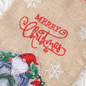 Linen Christmas wine gift bag with Merry Christmas embroidery and Santa gnome motif