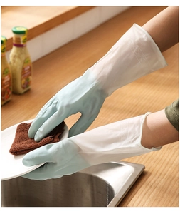 Blue kitchen gloves for dishwashing with textured palms used on a white ceramic plate