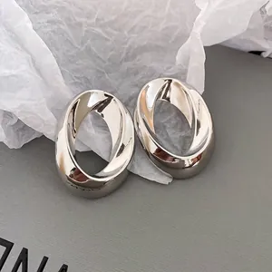 Minimalist silver polished twisted oval hoop earrings with high-shine mirror finish