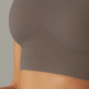 Seamless high-stretch taupe sports bra with wide ribbed underband and knit texture