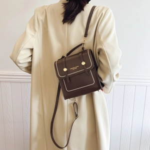 Deep brown vintage leather tote bag with white contrast stitching and gold buckle
