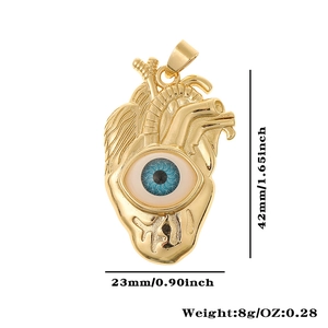 Detail showing gold heart pendant with blue evil eye and dimensions 42x23mm