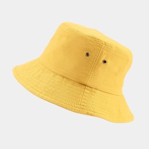 Classic yellow cotton bucket hat with breathable metal eyelets for outdoor sun protection