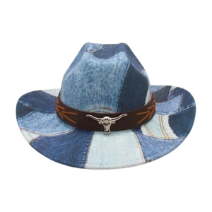 Detail of vintage denim patchwork western cowboy hat with leather band and metal bull head