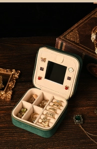 Detail view of emerald velvet jewelry box interior with mirror and ring slots