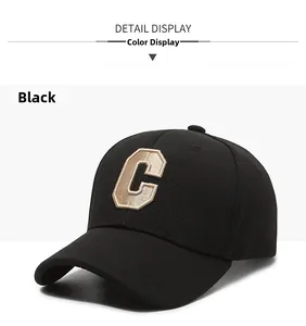 Close-up of the textured fabric and premium 3D gold-brown embroidered letter C on the cap