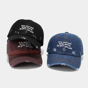 Detailed texture of distressed denim baseball caps with embroidery and frayed edges