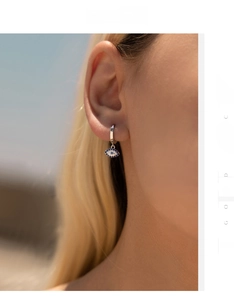 Close-up of S925 silver evil eye hoop earrings with blue and white zircons on model