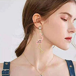 Close-up of pink flamingo tassel earrings featuring gemstones and gold-plated details