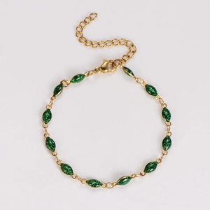 Detail of gold chain bracelet with 13 marquise-shaped dark green glitter charms and lobster clasp