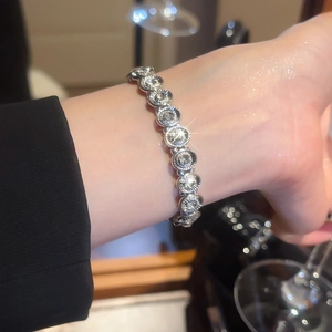 Close-up of sparkling silver tennis bracelet with cubic zirconia stones on female wrist