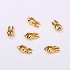 Set of six gold plated metal tooth shaped charms for DIY jewelry making and bracelets