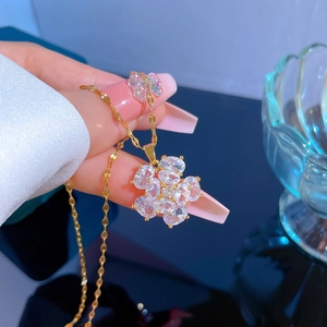 Detail of flower pendant necklace in gold with shimmering cubic zirconia crystals