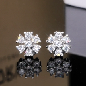 Macro shot of elegant floral stud earrings with sparkling round cubic zirconia crystals