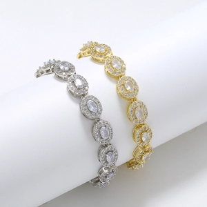 Detailed view of gold and silver plated oval bracelets with prong-set cubic zirconia