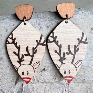 Bohemian wood texture earrings with reindeer pattern on a gray concrete surface