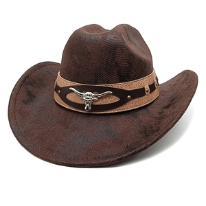 Detail of a brown cowboy hat featuring a braided texture and a metal bull head buckle