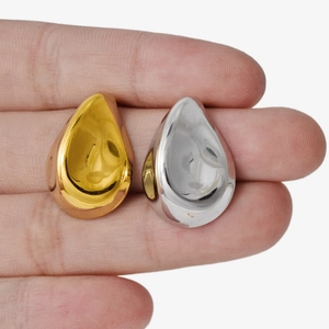 Minimalist 18k gold and silver chunky teardrop rings in a polished mirror finish