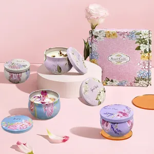 Floral scented candle gift set with 4 tin cans and pink gift box on a soft pink background