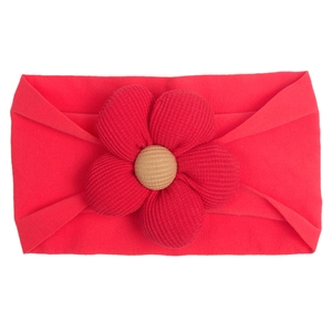 Detail of baby nylon headband with large red ribbed flower and khaki center on white