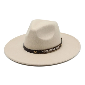 Detail of off-white wide brim fedora hat featuring woven leather band and gold rivets
