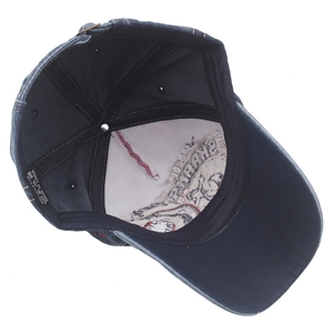Internal view of navy denim baseball cap showing 100% cotton label and stitching
